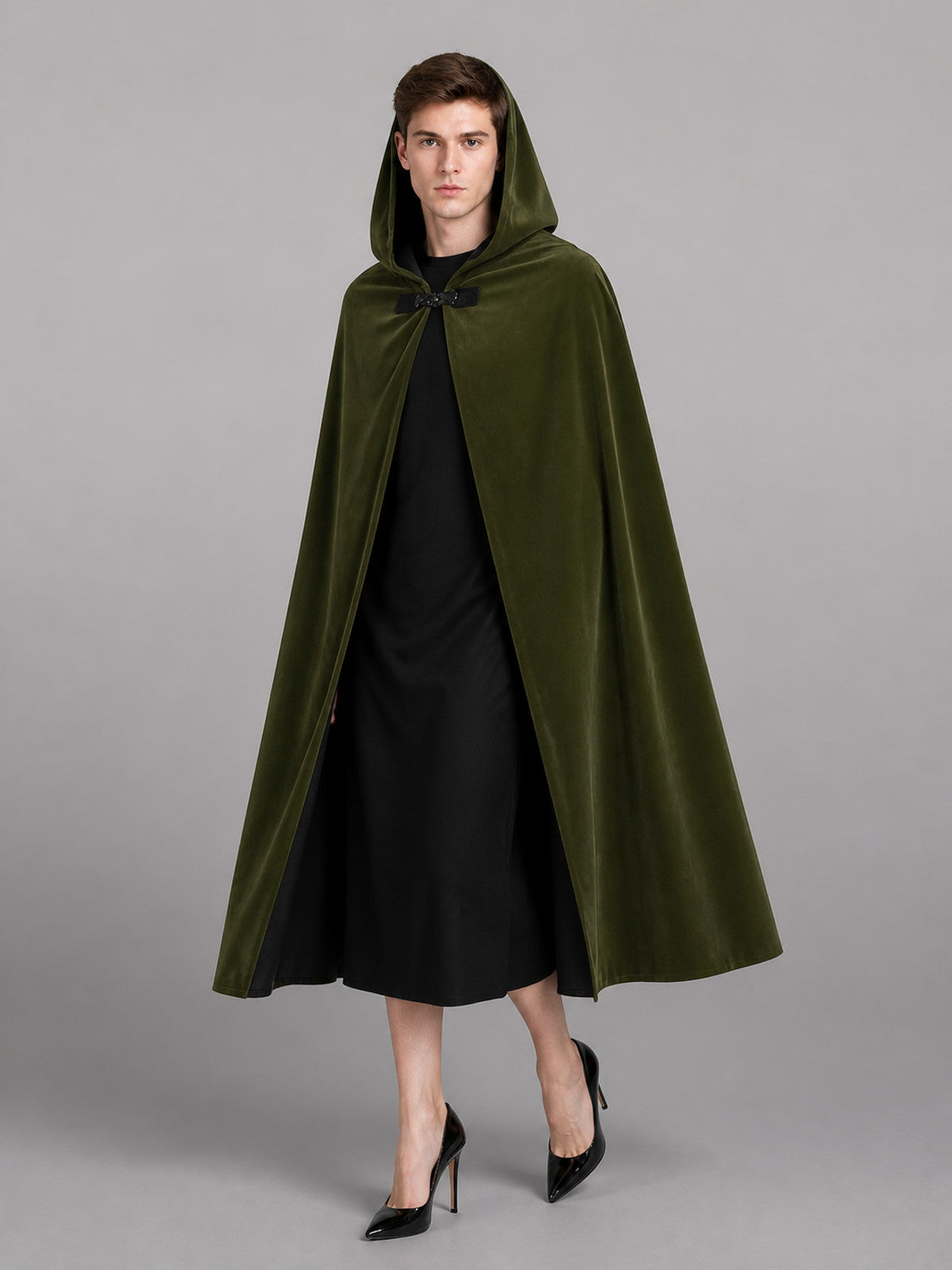 Green hooded cape with black lining, shown full-length on a model wearing the oversized hood up