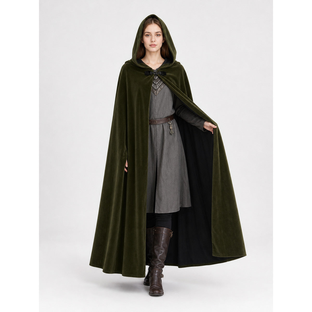Green hooded cape shown full-length on a model holding it open to reveal the black lining