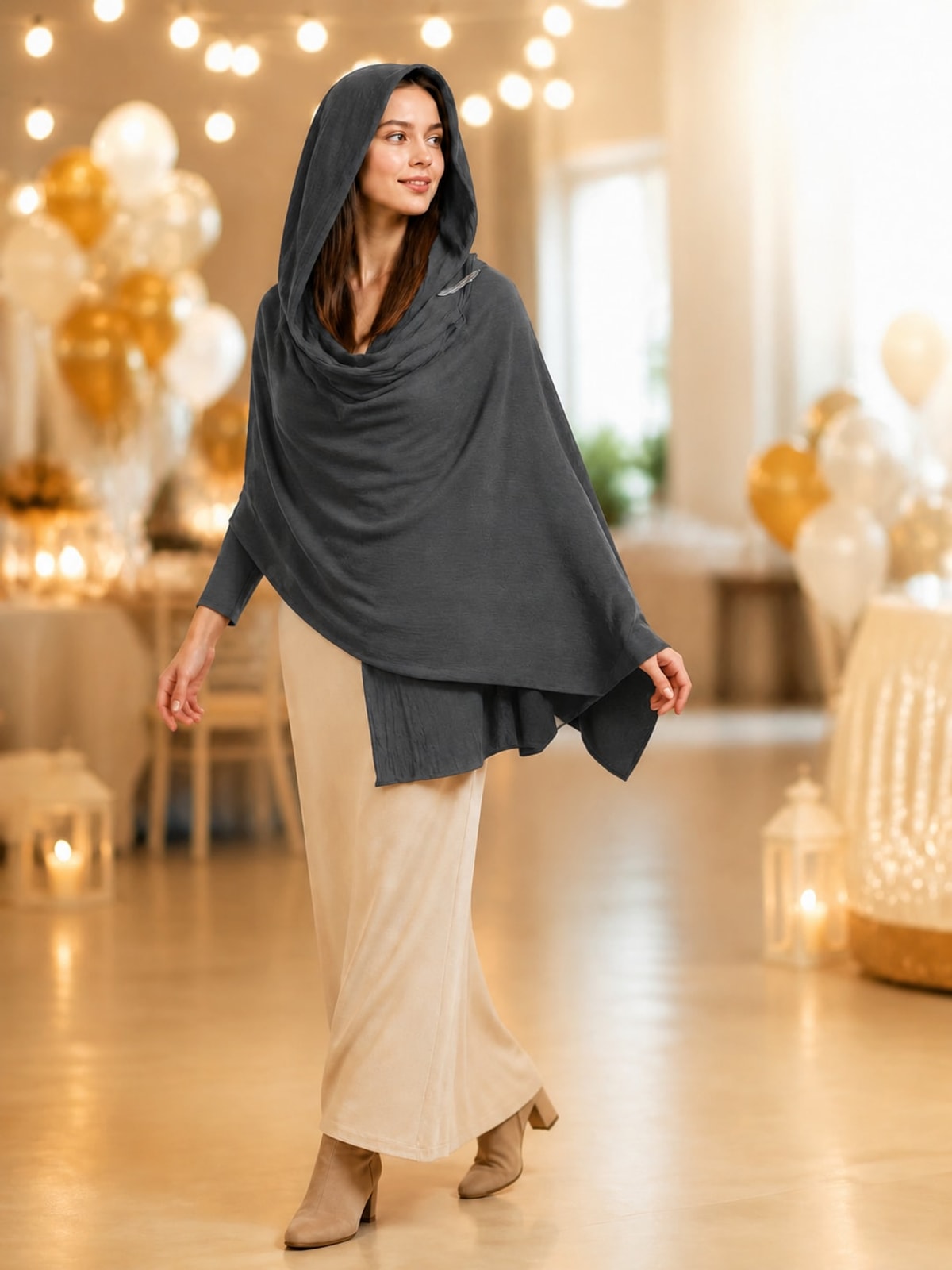 Charcoal gray hooded scarf cape worn over a cream skirt at an evening party