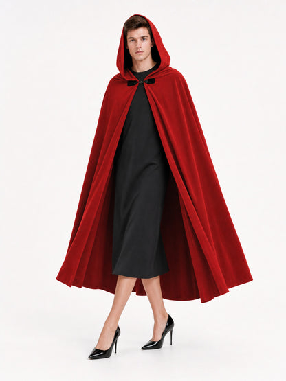 Red hooded cape with a black front toggle and long flowing panels, shown full-body on a model