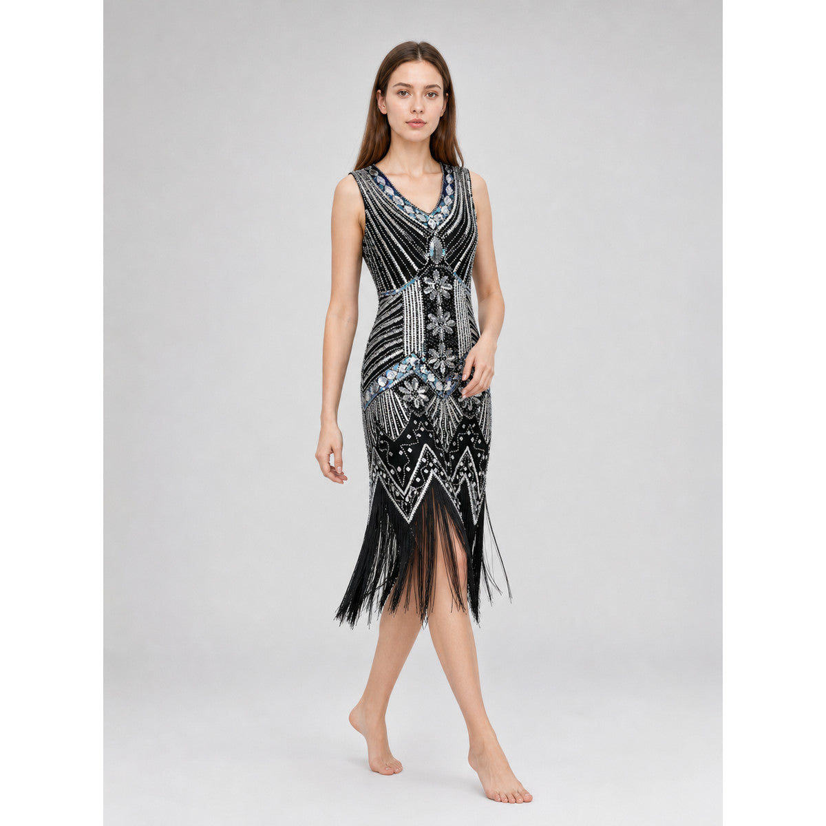 Sleeveless dress with a V-neckline and fitted silhouette, made from fabric featuring prominent bead and sequin embroidery. The decoration combines dense geometric patterns, chevron-shaped elements, and floral motifs, creating a striking loo