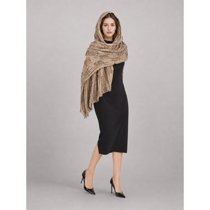 Khaki textured hooded scarf cape with long fringed ends, styled over a black dress on a full-body model