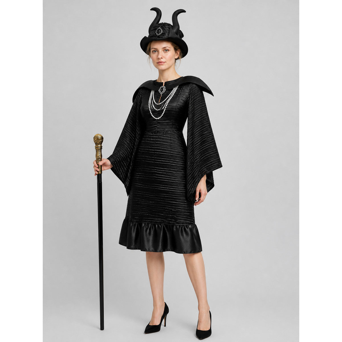 Black dark witch costume with horned hat, layered pearl necklace and staff, front view
