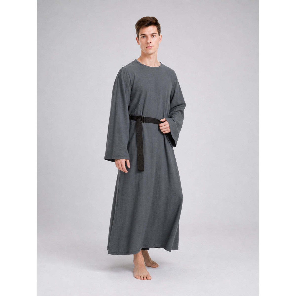 Full-body model wearing a loose gray robe with wide sleeves and a black belt, shown barefoot