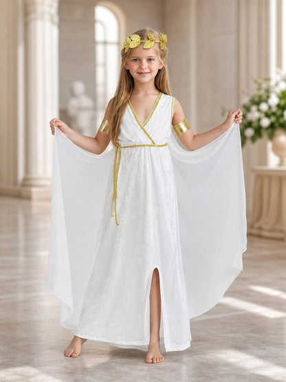 Full-body styled scene showing a child in a white flowing dress with gold trim, draped sleeves, gold arm bands, and a laurel wreath