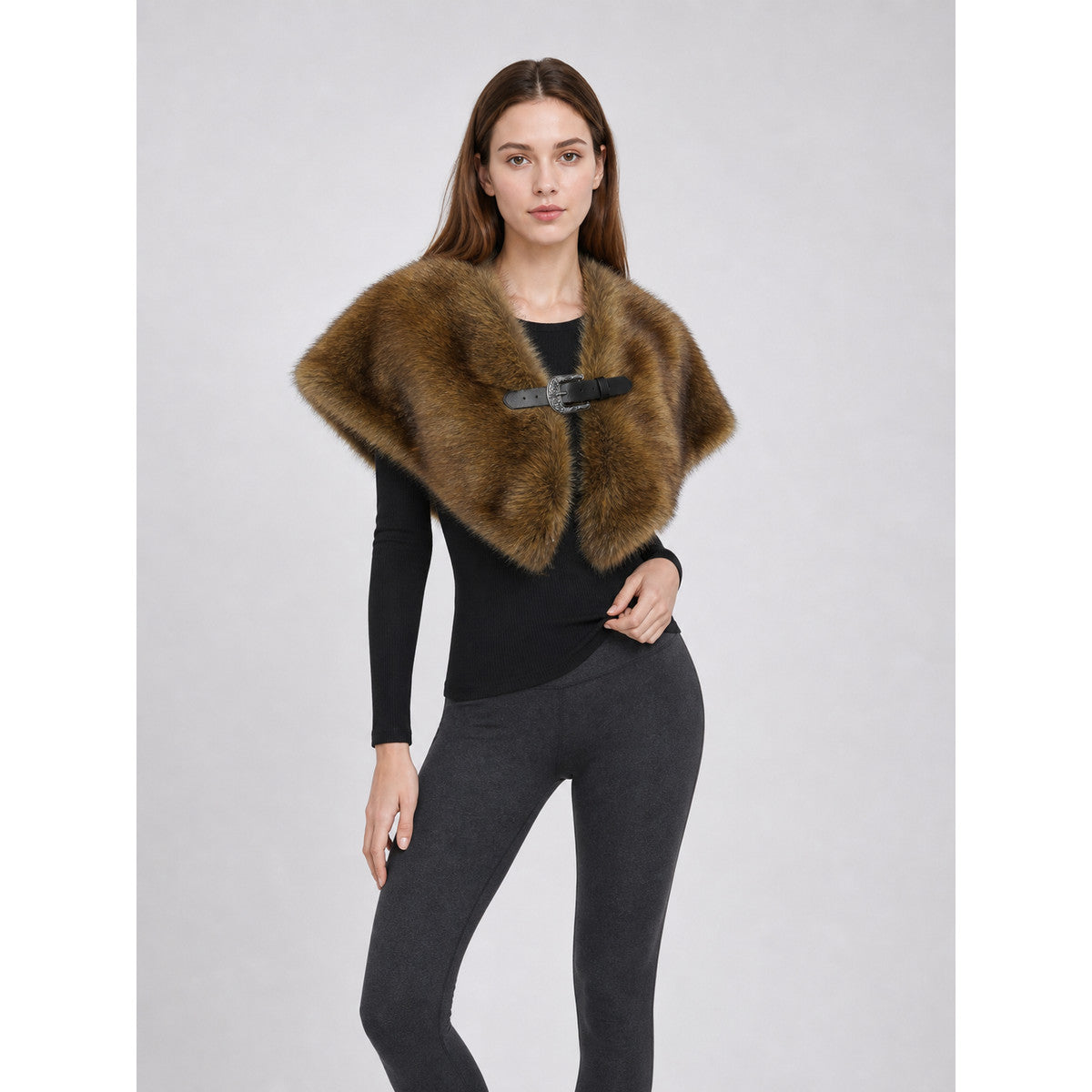 Brown shoulder cape with long fur-like pile shown on a model in a three-quarter view, featuring a black buckle closure
