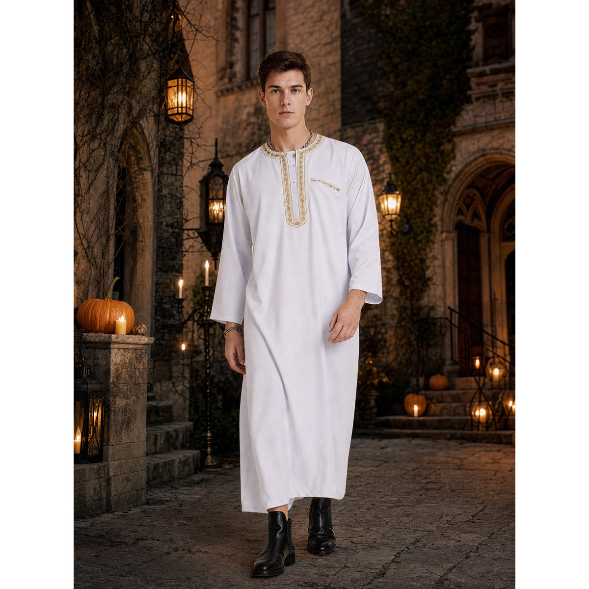 White long-sleeved robe with gold-toned trim, modeled in a lantern-lit outdoor setting with pumpkins and black boots