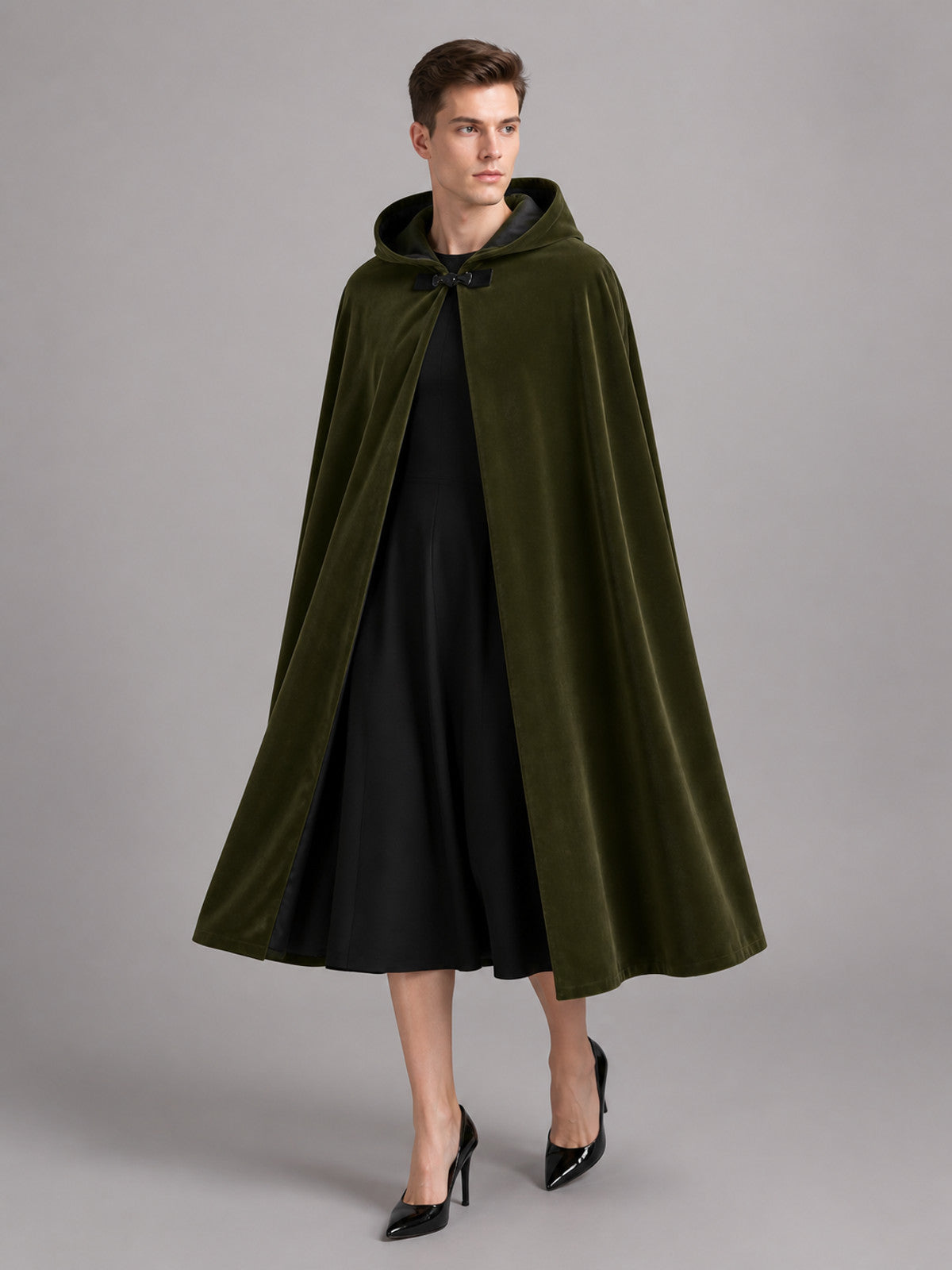 Green hooded cape with black lining, shown full-length on a model with the hood resting around the neck