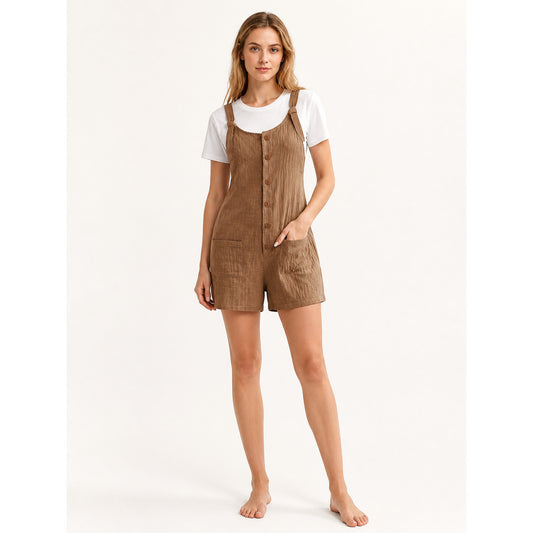 Brown textured short overalls with adjustable straps, front buttons, and pockets, modeled with a white T-shirt against a plain background