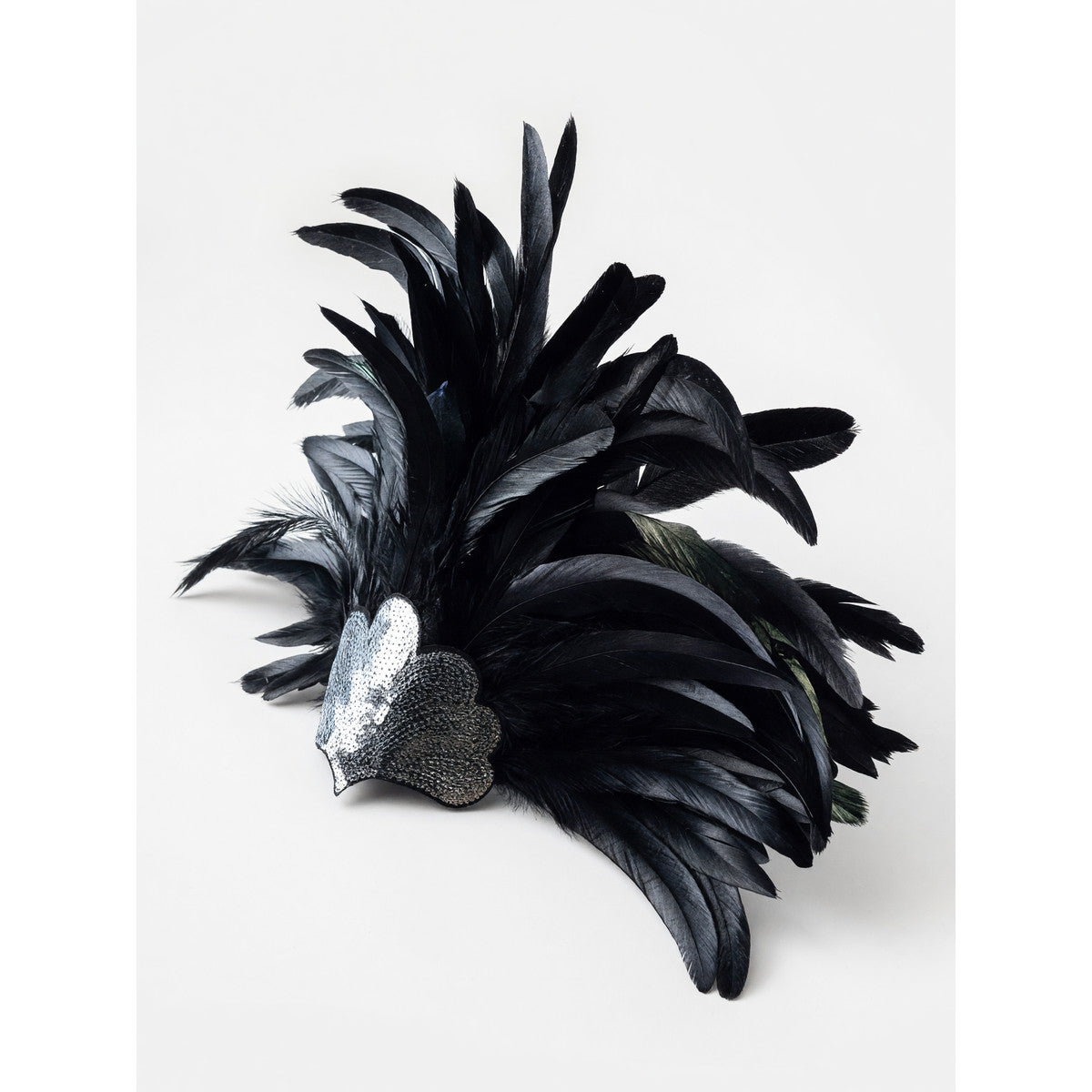 Feather carnival accessory with a silver heart