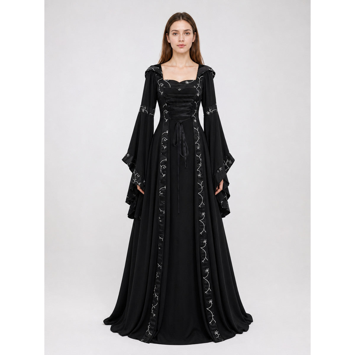 The dress is designed in a gothic style with elements of Victorian aesthetics. The model features a flared silhouette, a square neckline, and long sleeves with flared cuffs. The bodice is decorated with gathers that emphasize the garment’s 