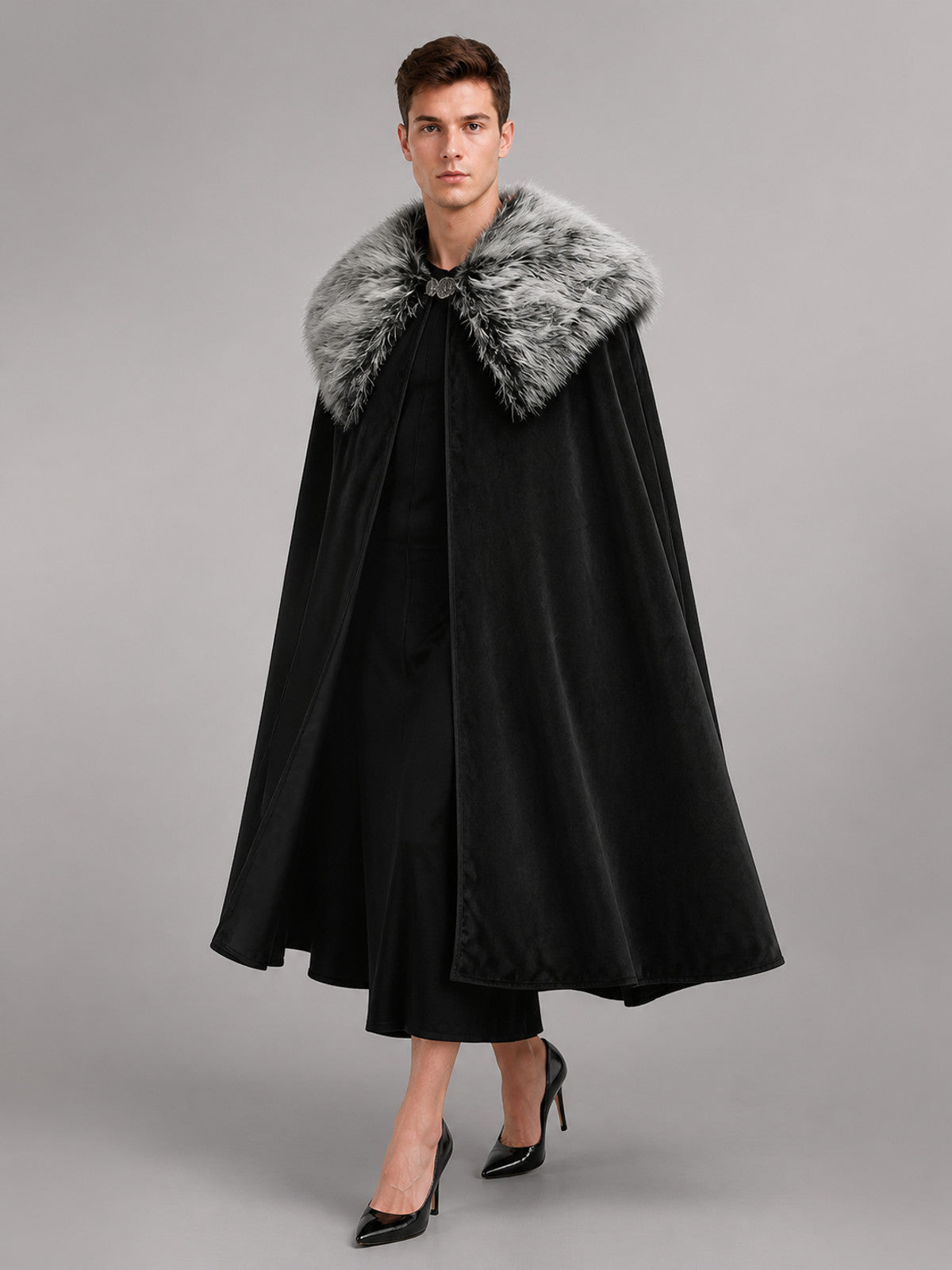 Black velvet-look cloak with a gray faux fur collar, shown full-length on a model against a gray studio background