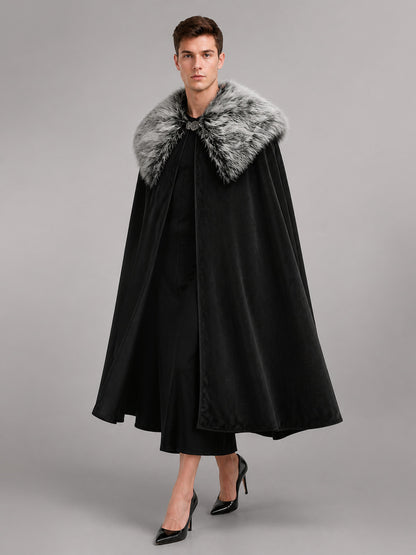 Black velvet-look cloak with a gray faux fur collar, shown full-length on a model against a gray studio background