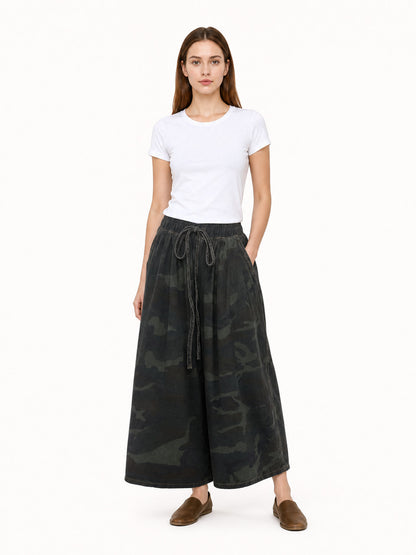 Dark camouflage wide-leg cropped jeans shown full-body on a model, with an elastic drawstring waist and side pockets