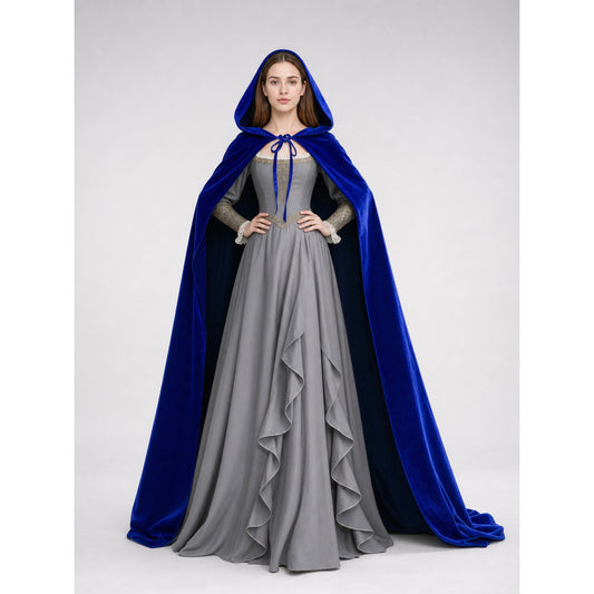 Blue velvet hooded cape worn full-length over a gray ruffled dress, shown front-facing on a model