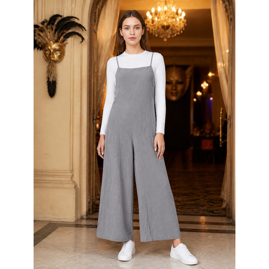 Gray wide-leg overalls with thin straps shown full-body on a model over a white long-sleeve top with white sneakers