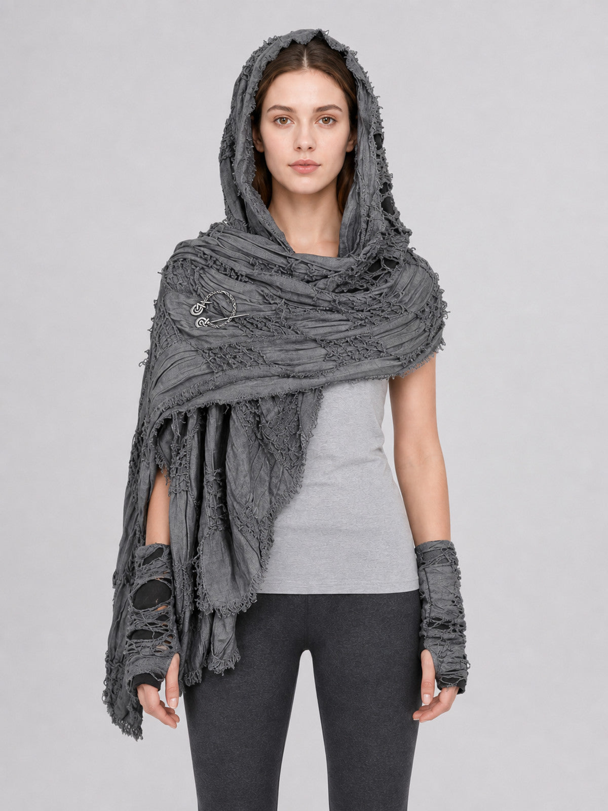 Gray hooded scarf with matching fingerless gloves, distressed textured fabric and fringed edges, shown full-body on a model