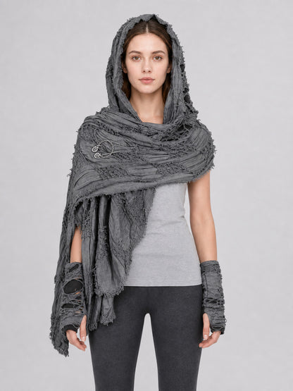 Gray hooded scarf with matching fingerless gloves, distressed textured fabric and fringed edges, shown full-body on a model