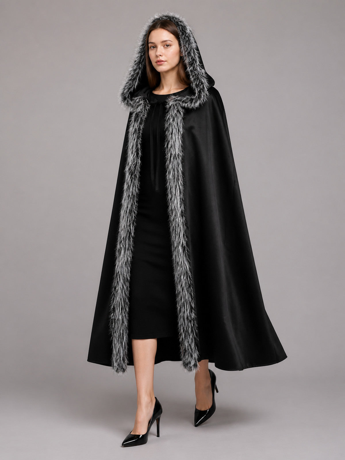 Black hooded cloak with gray faux-fur trim, shown full-length on a model against a gray studio background