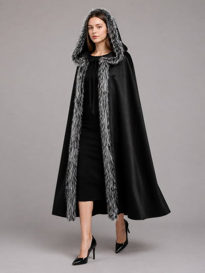 Black hooded cloak with gray faux-fur trim, shown full-length on a model against a gray studio background