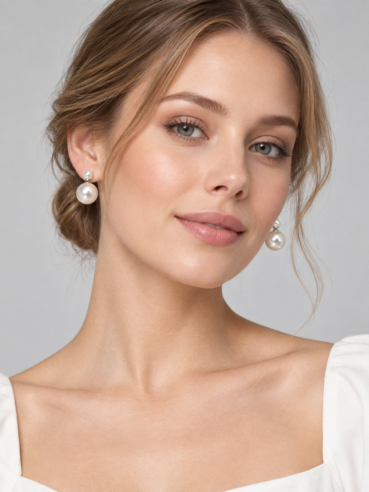 Earrings with white glossy round beads in two sizes