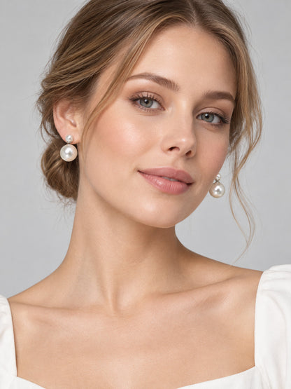 Earrings with white glossy round beads in two sizes