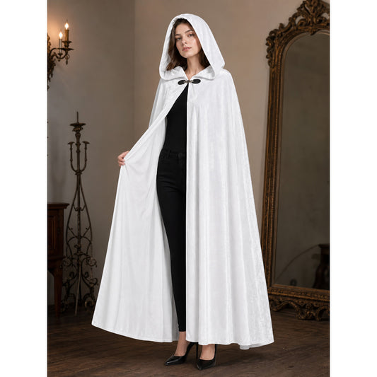 White hooded cape with a black clasp, shown full-length on a model in a styled interior