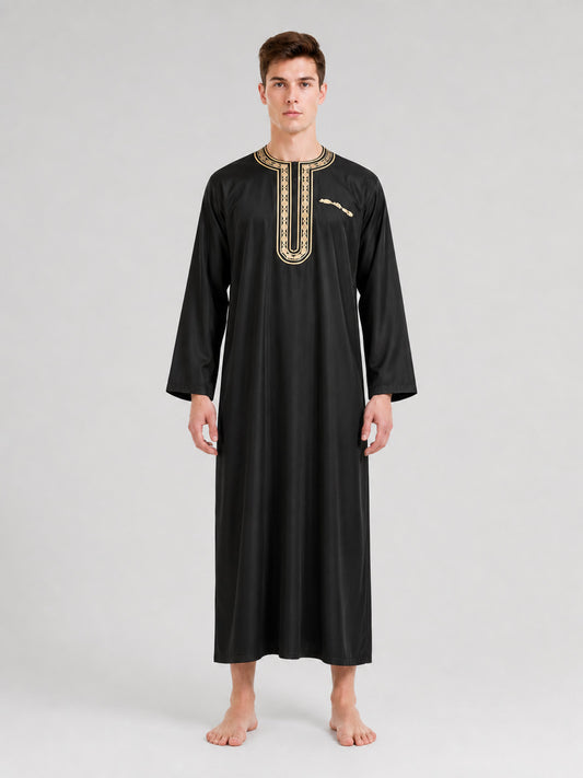 Full-body model wearing a long black robe with a gold-trimmed round neckline and front placket