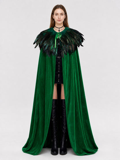 Front view of a green velvet cape on a model with black and green feather trim and a ribbon closure