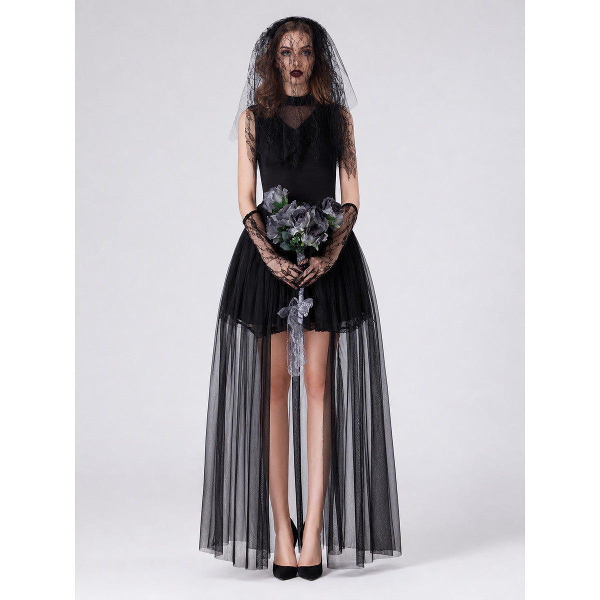 Model wearing a black gothic zombie bride Halloween costume: high-low tulle dress, black lace veil and long lace gloves, front view