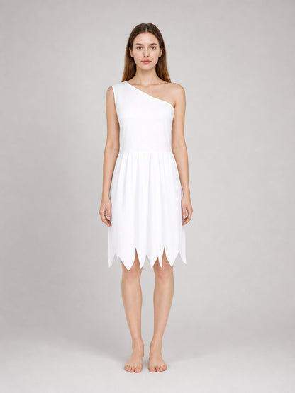 White one-shoulder costume dress in soft-looking fabric, shown full-body on a model with a gathered waist and pointed hem