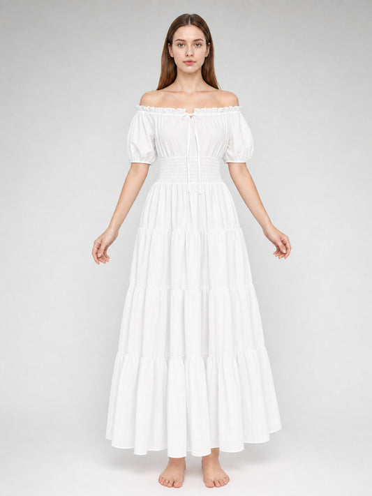 White lightweight-looking off-shoulder maxi dress on a full-body model, with short puff sleeves, a smocked waist, and tiered floor-length skirt
