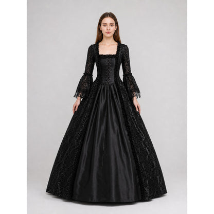 The black dress is designed in the aesthetic of a Victorian-era Gothic costume. The model features a floor-length silhouette, a fitted bodice with a square neckline, and decorative lacing or trim on the front. The long flared sleeves end in