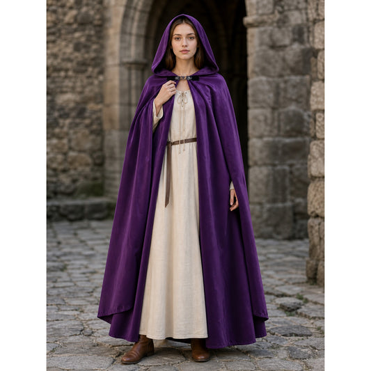 Purple hooded cloak with a smooth sheen, front clasp, and long draped panels shown full-body on a model outdoors