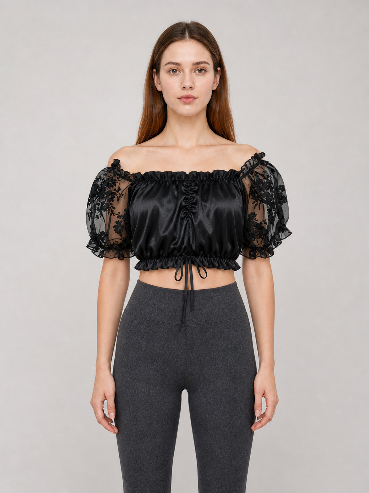 The blouse is black: the main body is made of opaque, smooth fabric