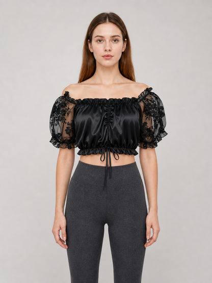 The blouse is black: the main body is made of opaque, smooth fabric