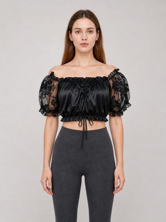 The blouse is black: the main body is made of opaque, smooth fabric front view