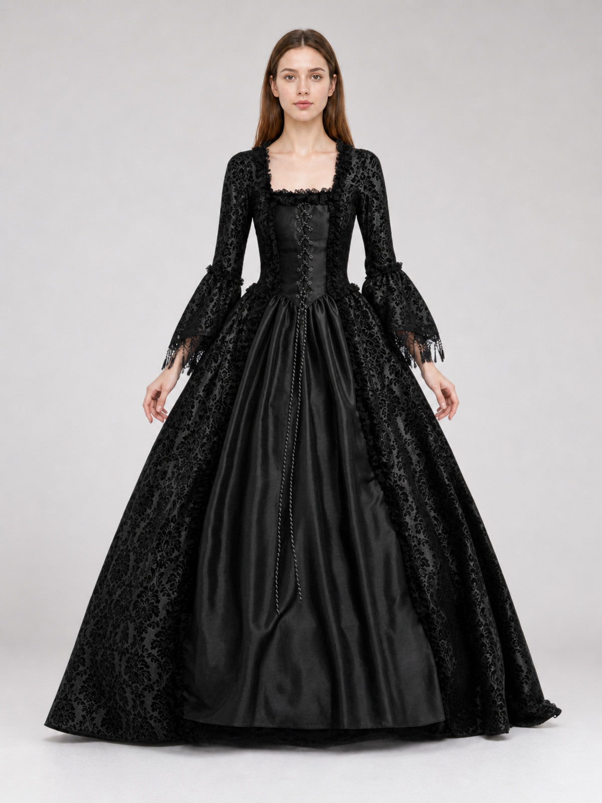 Black dress designed in the aesthetic of a Victorian-era Gothic costume. The front view