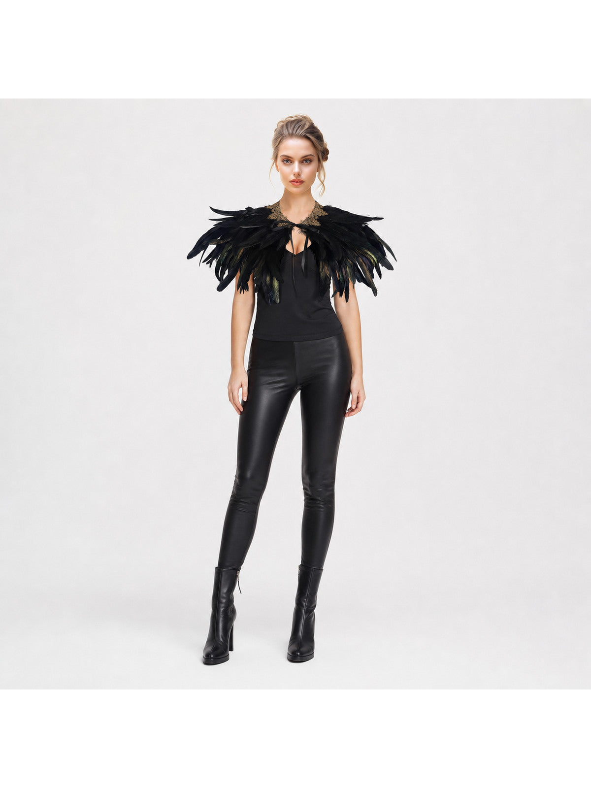 Feather capelet, black with layered shoulder feathers and a gold-trimmed collar, shown on a full-body model against a white background