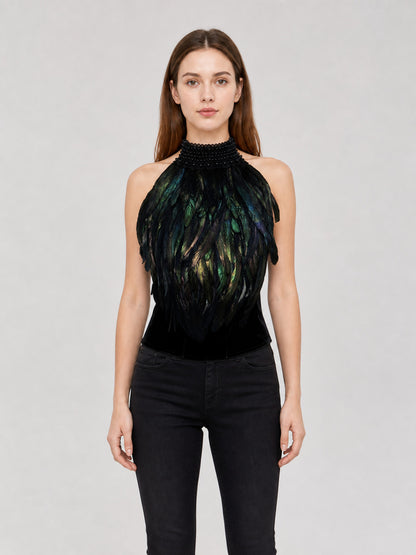 Black halter top with iridescent green and blue feathers and a beaded high collar, shown front-facing on a model