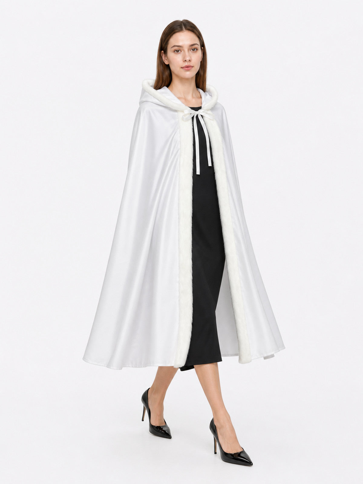 White hooded cape with fluffy trim and front ties, shown full-length on a model over a black dress