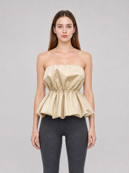Beige strapless bustier top with peplum front view