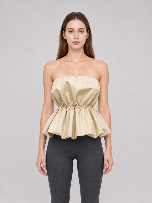 Beige strapless bustier top with peplum front view