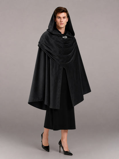 Black hooded cloak with layered draping and front clasp, shown full-body on a model over a black dress
