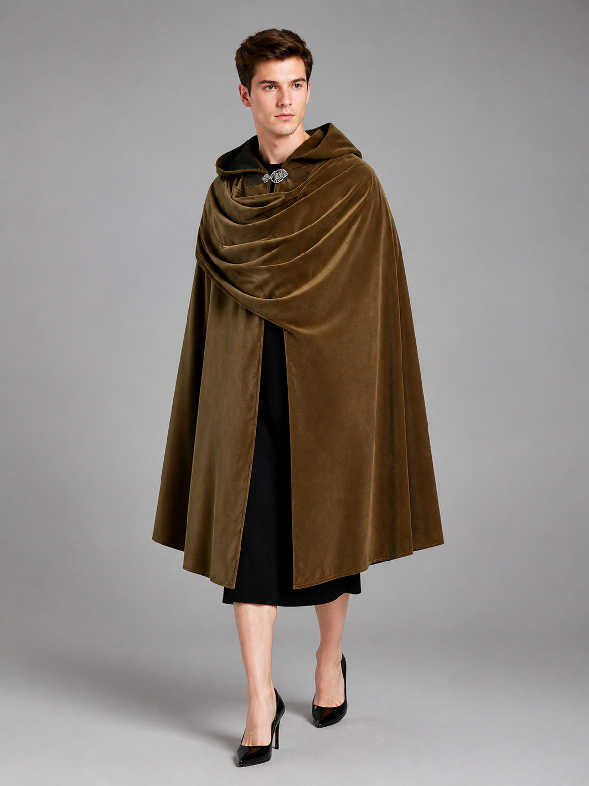 Brown velvet-look hooded cloak shown full-length on a model, with a draped front, metal clasp, and black garment visible underneath