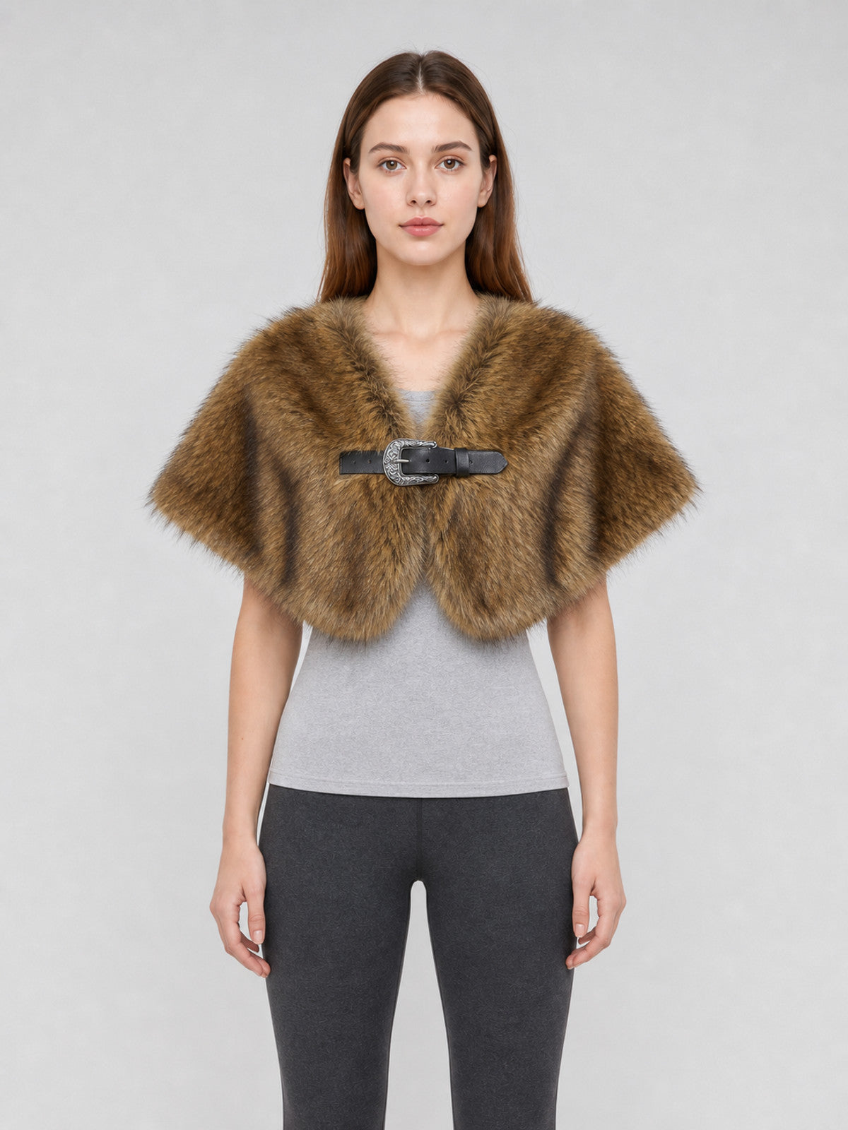 Brown fur-textured shoulder cape shown on a model, with a wide draped shape and black buckle closure at the front