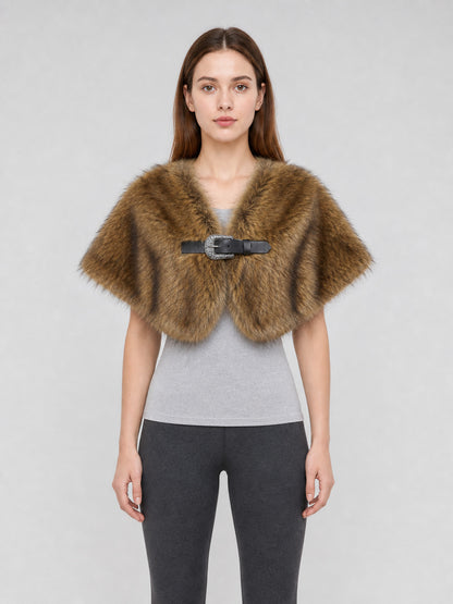 Brown fur-textured shoulder cape shown on a model, with a wide draped shape and black buckle closure at the front