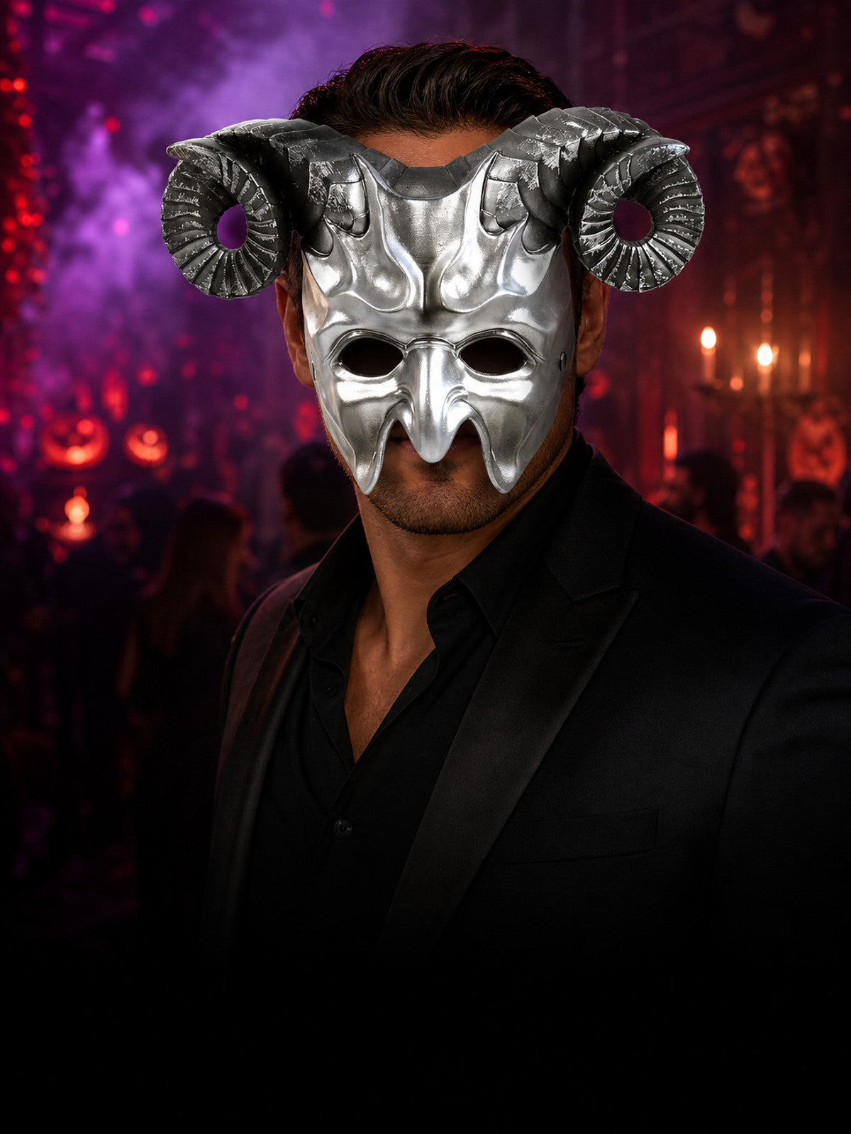 Silver metallic full-face mask with black curled horns worn by a person in a dark Halloween party setting