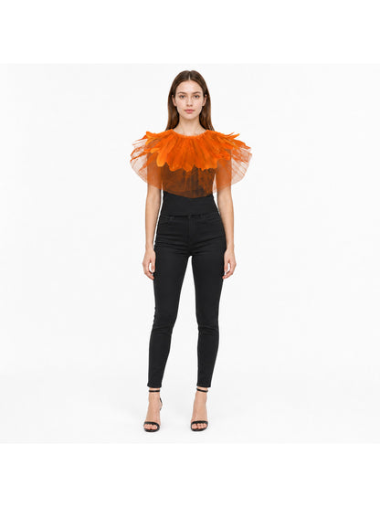 Orange feather and sheer mesh shoulder cape shown on a full-body model wearing a black top, fitted pants, and sandals