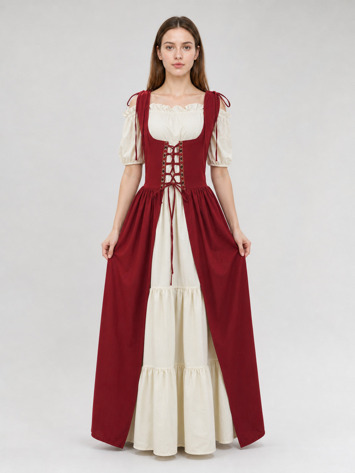 Two-piece burgundy and cream dress shown full-body on a model, with a laced bodice, puff sleeves, and tiered skirt